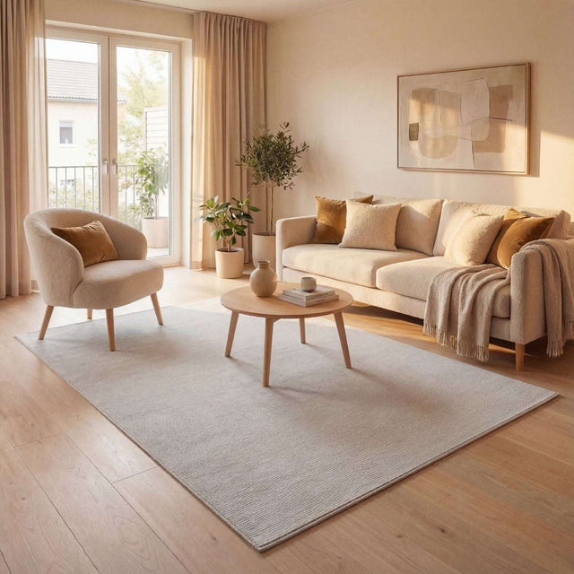 Light beige Striped Rug placed in a modern living room with elegant furnishings and natural light