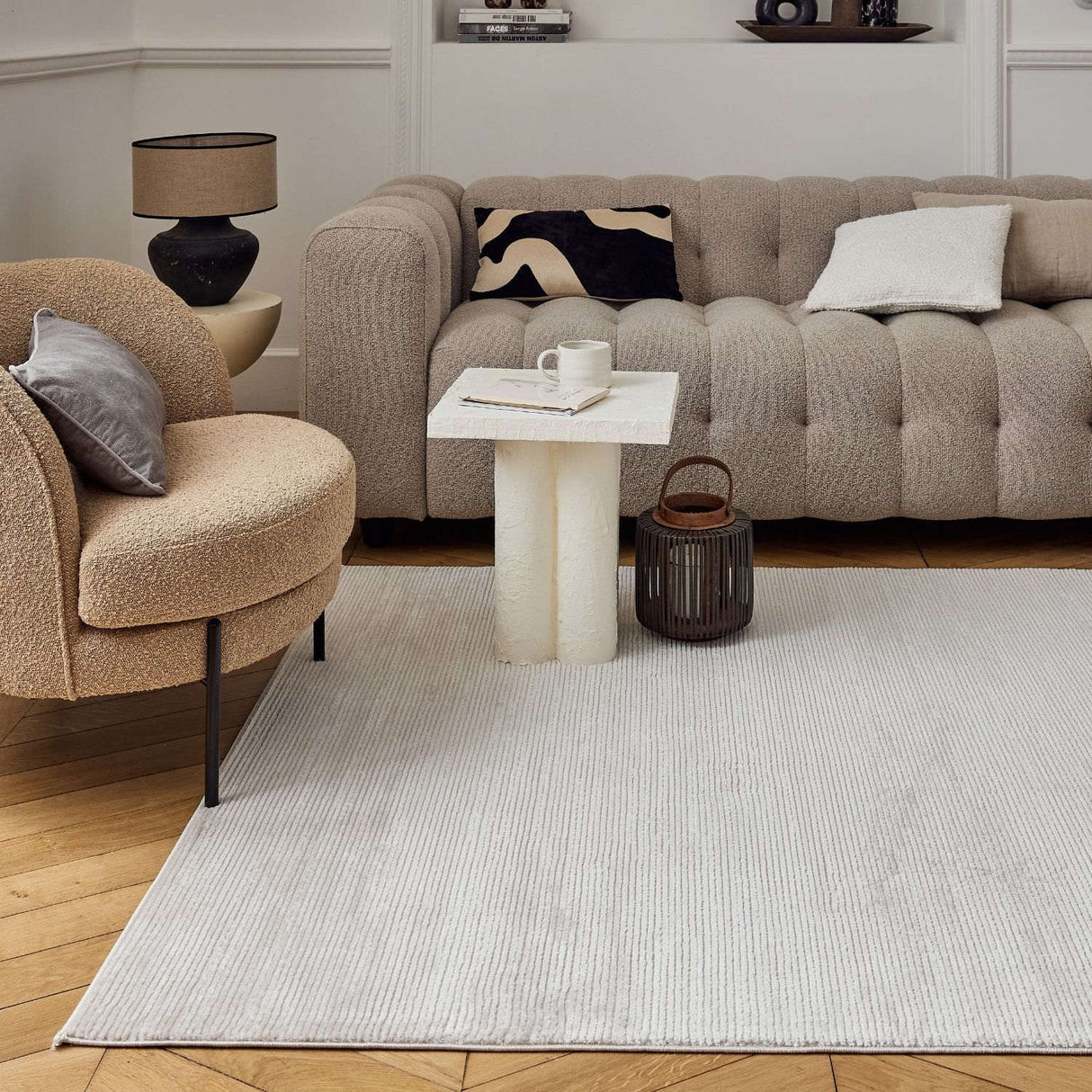 Modern living room featuring a soft Striped Rug beneath a stylish coffee table and plush sofa