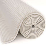 Cream Striped Rug rolled up, showcasing its soft texture and modern design for home decor