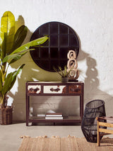 Orsina Striped Rug placed under a stylish console table with decorative plants and a round mirror
