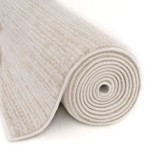 Soft and plush Striped Rug rolled up showcasing its light cream colour and textured design