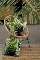 Orsina Striped Rug paired with tropical cushions in a stylish living room setting