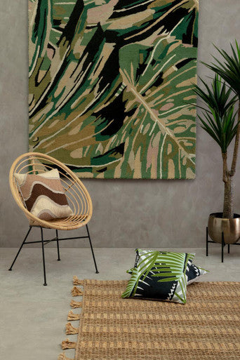 Orsina Striped Rug in natural tones, complementing indoor plants and modern decor