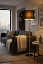 Orsina Floor Lamp with a stylish black shade and glass accents in a modern living room setting