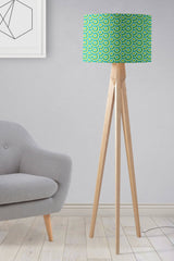 Shadow Bright lampshade in green geometric design on a stylish wooden floor lamp in a modern living room