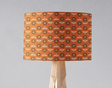 Orange patterned lampshade featuring floral designs, ideal for brightening up any room