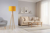 Modern lampshade in yellow patterned design on a stylish floor lamp in a bright living room