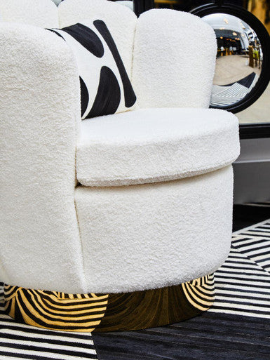 Orsina Swivel Chair in white faux fur with round base and black patterned cushion