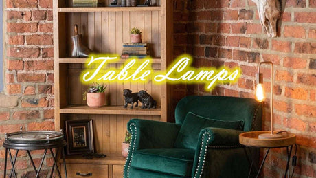 Stylish Orsina Table Lamp beside a green armchair in a rustic living room setting