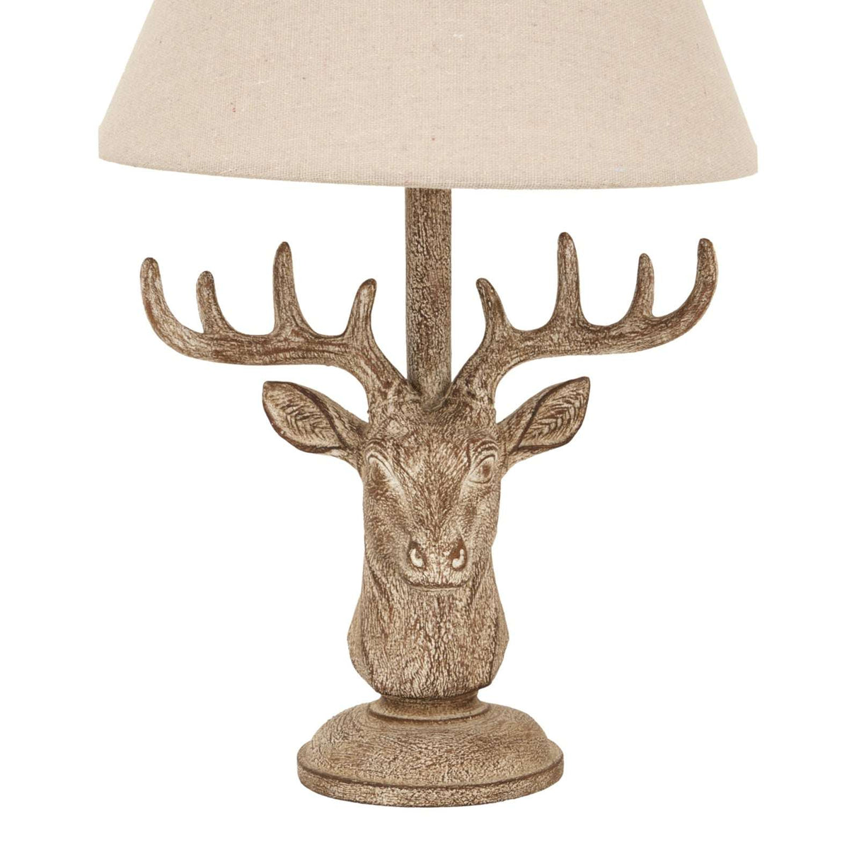 Rustic table lamp with a deer head base and neutral fabric shade for a charming accent