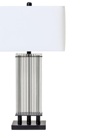 Orsina Table Lamp with a sleek design featuring a clear striped base and a white shade