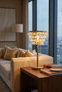 Stylish Orsina table lamp with crystal accents, illuminating a modern living space beside a sofa