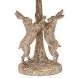 Unique table lamp featuring two rabbits playfully climbing a textured tree trunk base