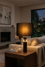 Orsina Table Lamp with a warm glow, stylish design, and a black lampshade for modern living spaces