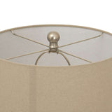 Close-up of a ceramic table lamp with a beige lampshade and metal support structure
