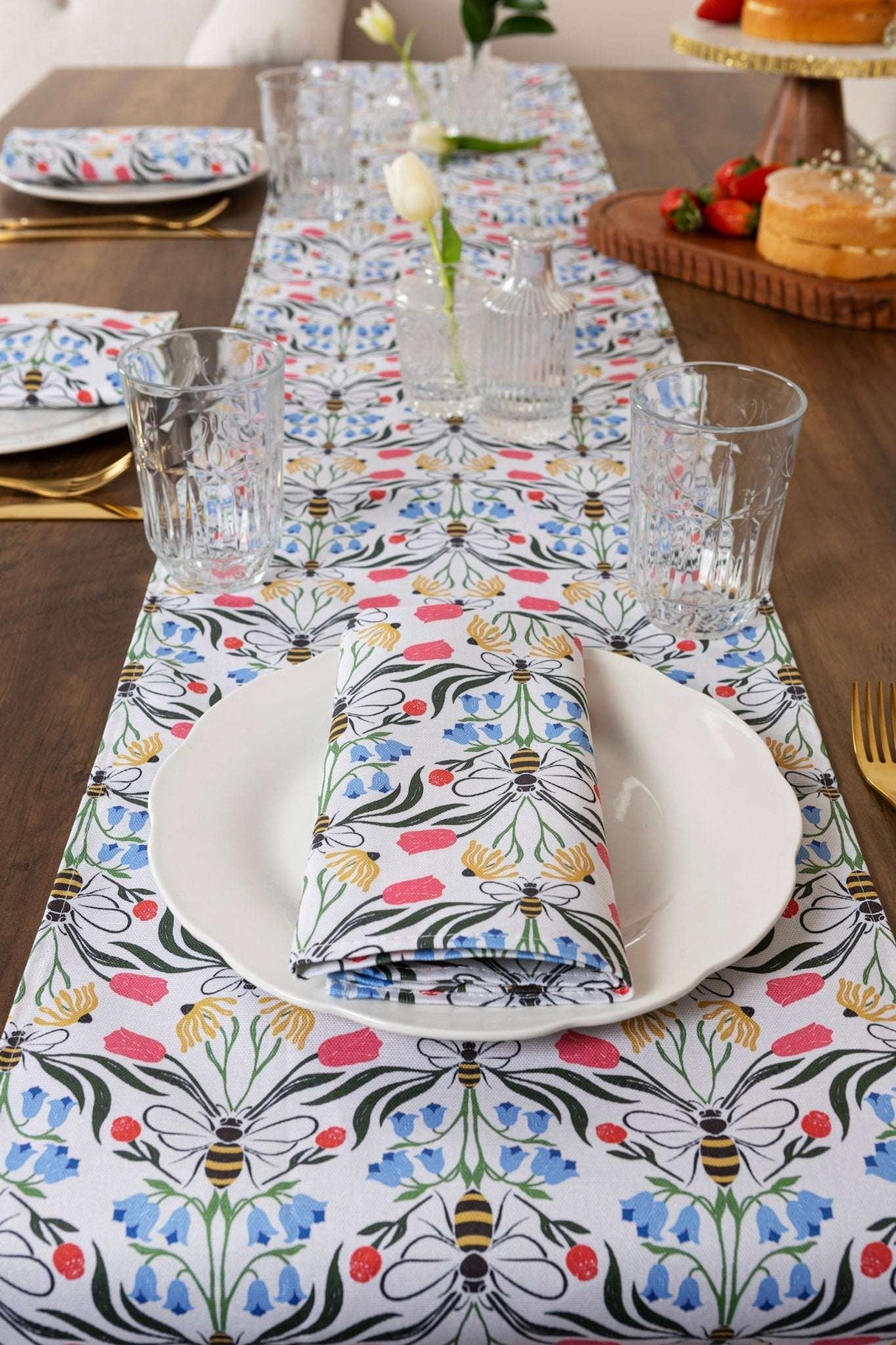 Colourful floral Table Runner on a wooden dining table set with plates and glasses