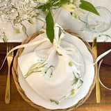 Elegant floral table setting featuring a white Table Runner and matching napkin for stylish dining