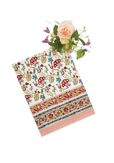 Brightly patterned Casa by Josephine Jenno tablecloth with floral designs and a coordinating pink border