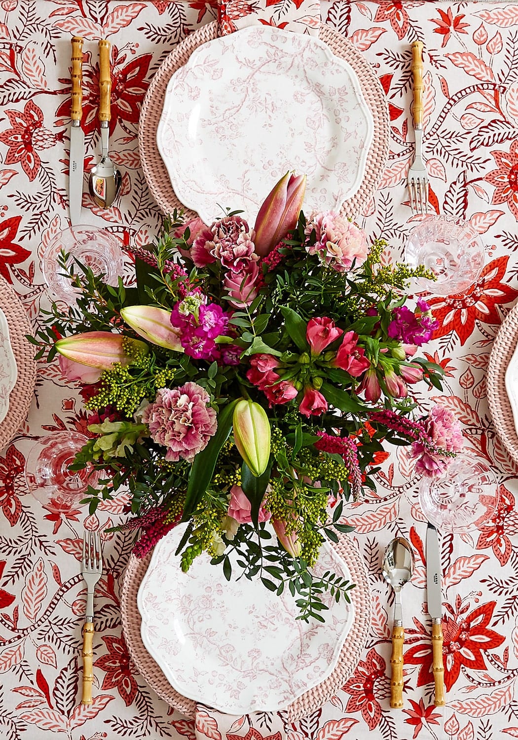 Casa by Josephine Jenno floral tablecloth with elegant dinnerware and vibrant floral centrepiece