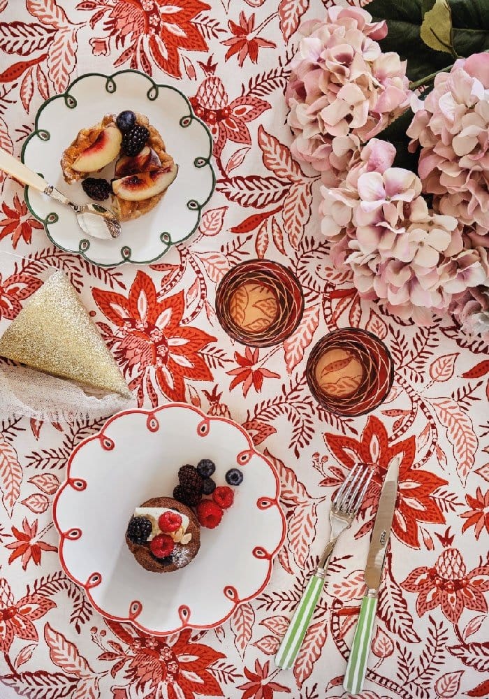 Casa by Josephine Jenno floral tablecloth featuring red and white patterns with elegant table settings