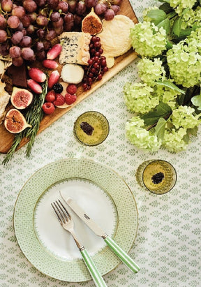 Elegant Casa by Josephine Jenno tablecloth with floral design, set for a dining experience