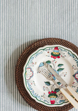 Casa by Josephine Jenno striped Tablecloth with decorative plates and cutlery on top