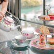Elegant Afternoon Tea Set featuring floral teapot, cups, and tiered stand with assorted pastries