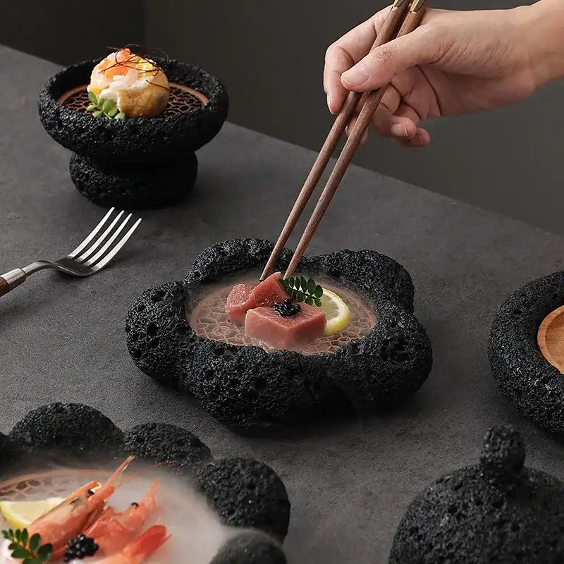 Stylish Nisu Home tableware featuring unique black stone bowls and chopsticks for elegant dining