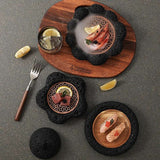 Stylish Nisu Home tableware set featuring elegant black stone dishes and wooden serving board