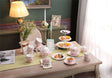 Elegant floral porcelain tea set with a two-tier cake stand, perfect for afternoon tea gatherings