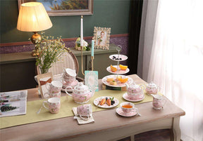 Elegant floral porcelain tea set with a two-tier cake stand, perfect for afternoon tea gatherings