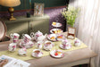 Elegant floral tea set with a Cake Stand displayed on a stylish table for a sophisticated tea party
