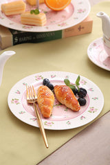 Elegant Cake Stand featuring floral design, perfect for serving pastries and desserts at gatherings