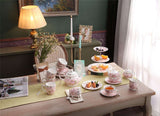 Elegant pink floral Cake Stand on a beautifully set tea table with pastries and fruits