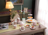 Elegant pink floral Cake Stand on a beautifully set tea table with pastries and fruits