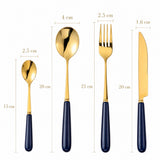 Elegant KitchBoom Cutlery Set in gold and navy featuring spoon, fork, knife and dessert spoon