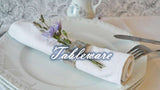 Elegant white Dinner Plates from London Boutique Lifestyle with decorative napkin and floral accent