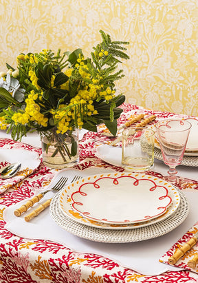 Casa by Josephine Jenno Lunch Plate decorated with red scallop design on a patterned dining table setting