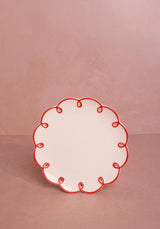 Casa by Josephine Jenno Side Plates with a decorative red scalloped edge on a white surface