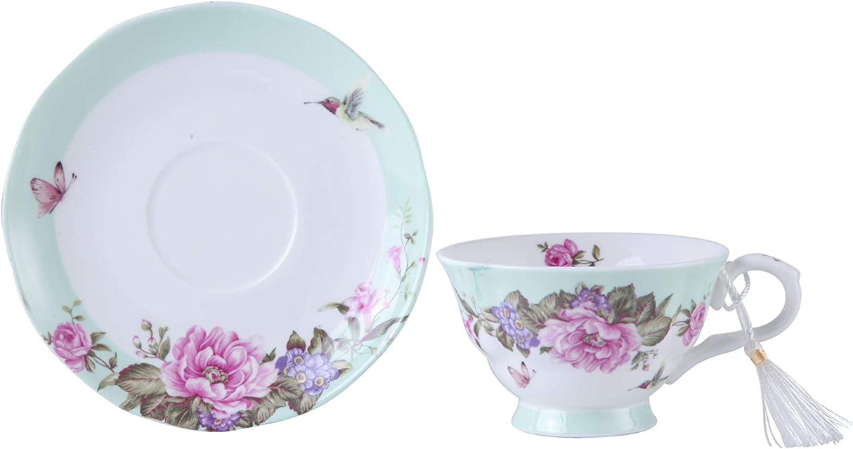 Elegant floral tea cup and saucer set featuring pastel colours and intricate designs with butterflies