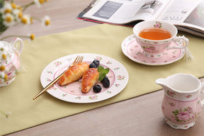 Elegant pink floral tea cups from London Boutique Lifestyle with pastries and berries on a pastel table setting