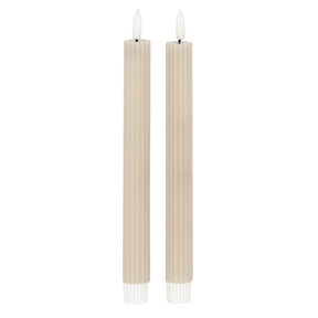 Set of two beige taper candles with ribbed design for elegant table decor