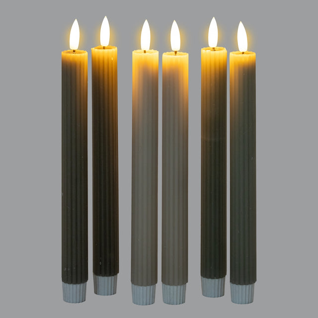 Set of six Shades 4 Seasons taper candles in various earthy colours with warm flickering flames