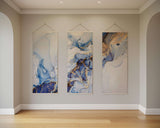 Elegant Printworks tapestry featuring three abstract designs in blue and gold tones, perfect for home decor