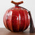 Nisu Home Decorative Red Tea Jar with Unique Shape and Tassel Detail for Elegant Storage