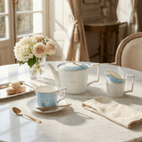 Elegant KitchBoom Tea Set with Blue Design including Teapot, Cups, and Milk Jug on a Marble Table