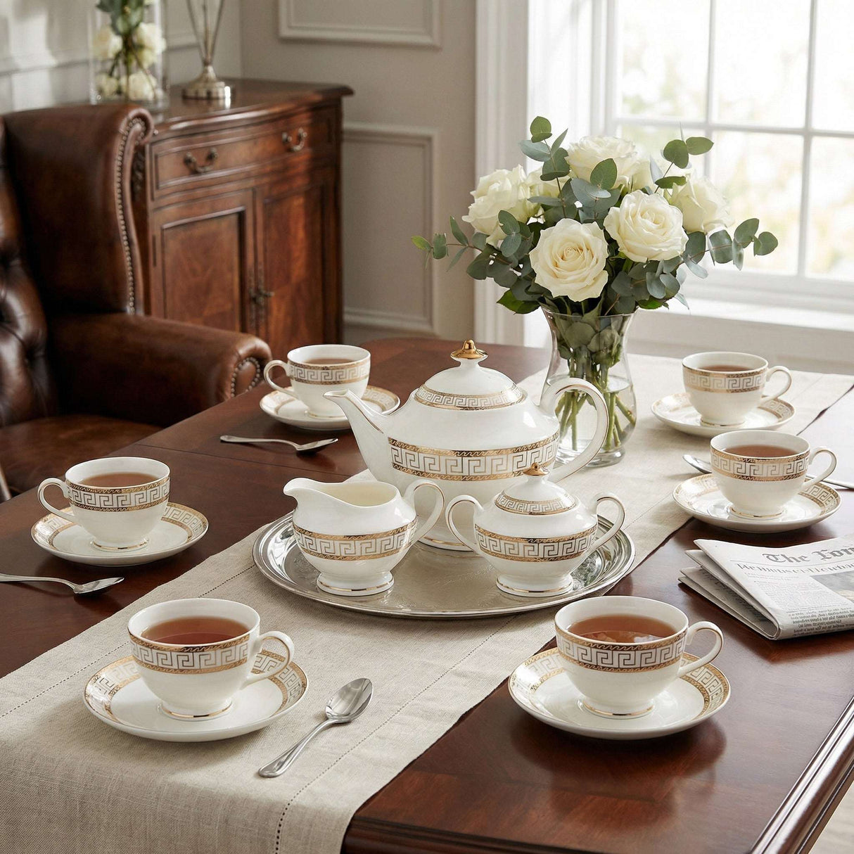 KitchBoom elegant Tea Set with fine porcelain cups, teapot and decorative tray arranged on a dining table