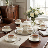 KitchBoom elegant Tea Set with fine porcelain cups, teapot and decorative tray arranged on a dining table