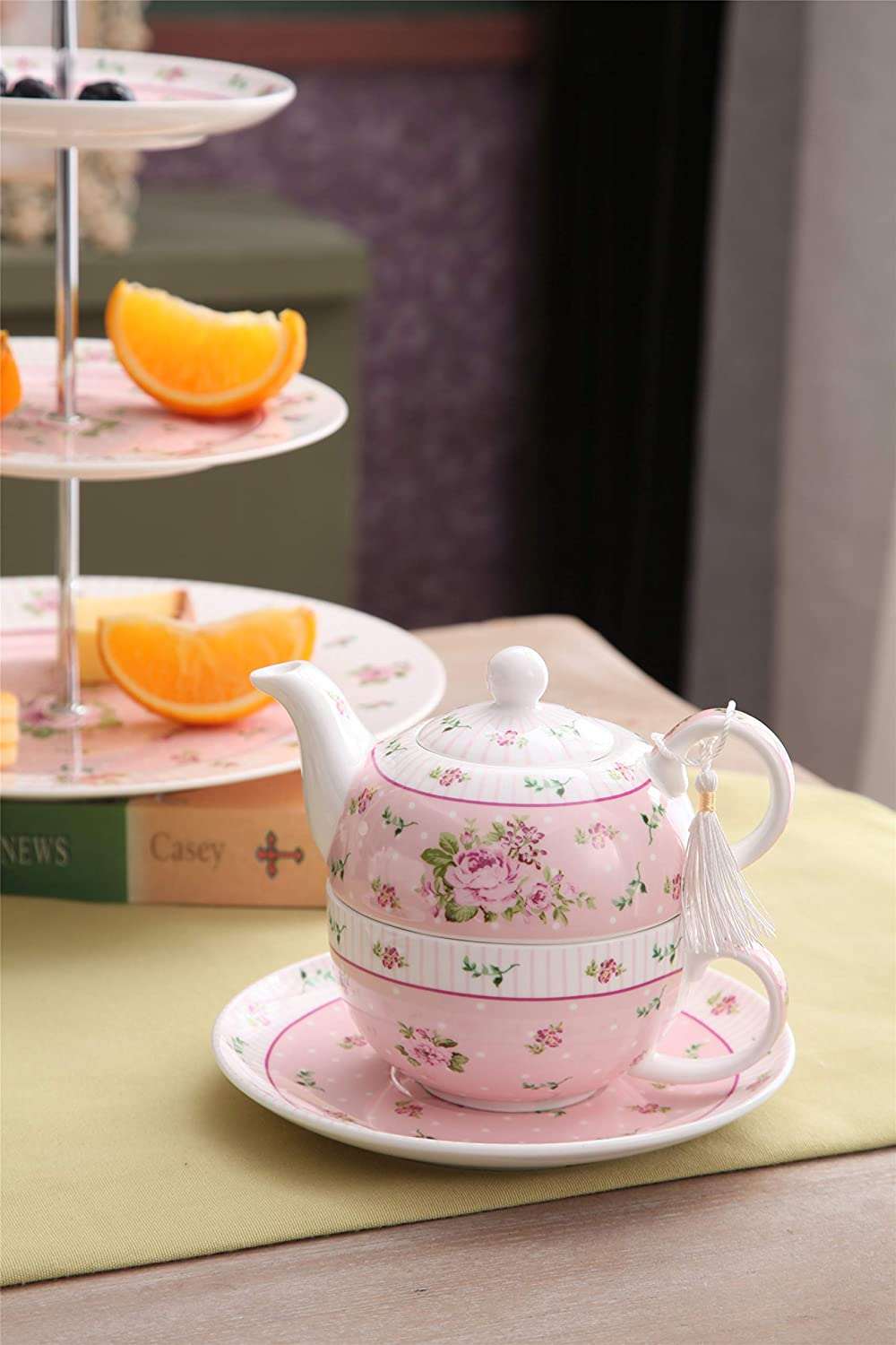 Elegant pink floral tea set with teapot and matching cup, perfect for afternoon tea