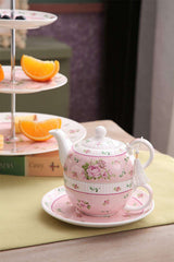 Elegant pink floral tea set with teapot and matching cup, perfect for afternoon tea